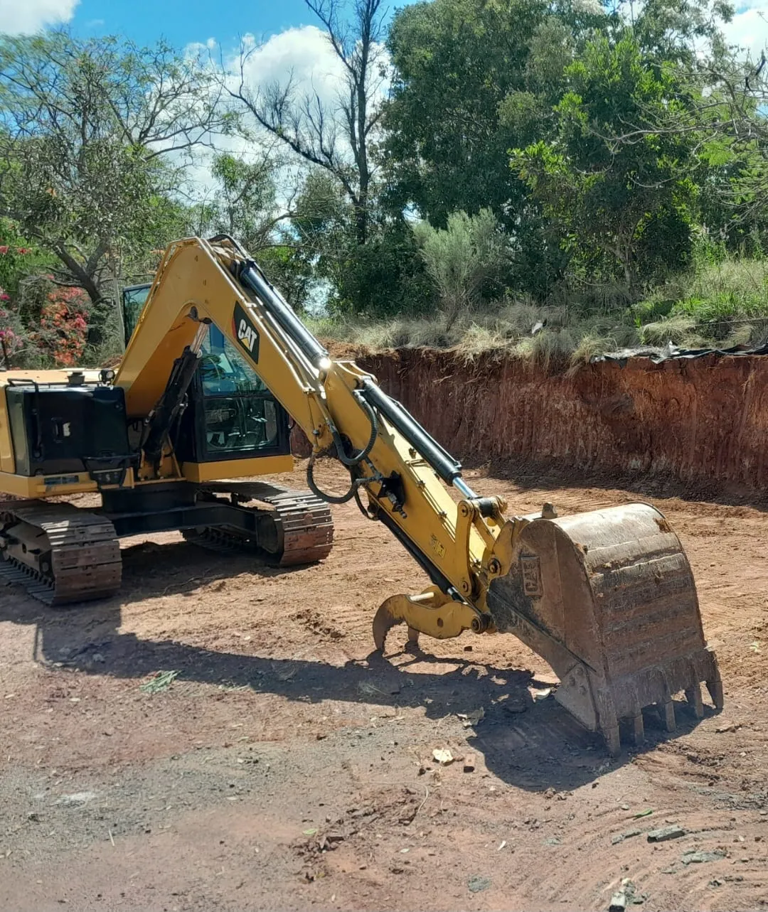Abel's excavator on a cleared red-dirt site